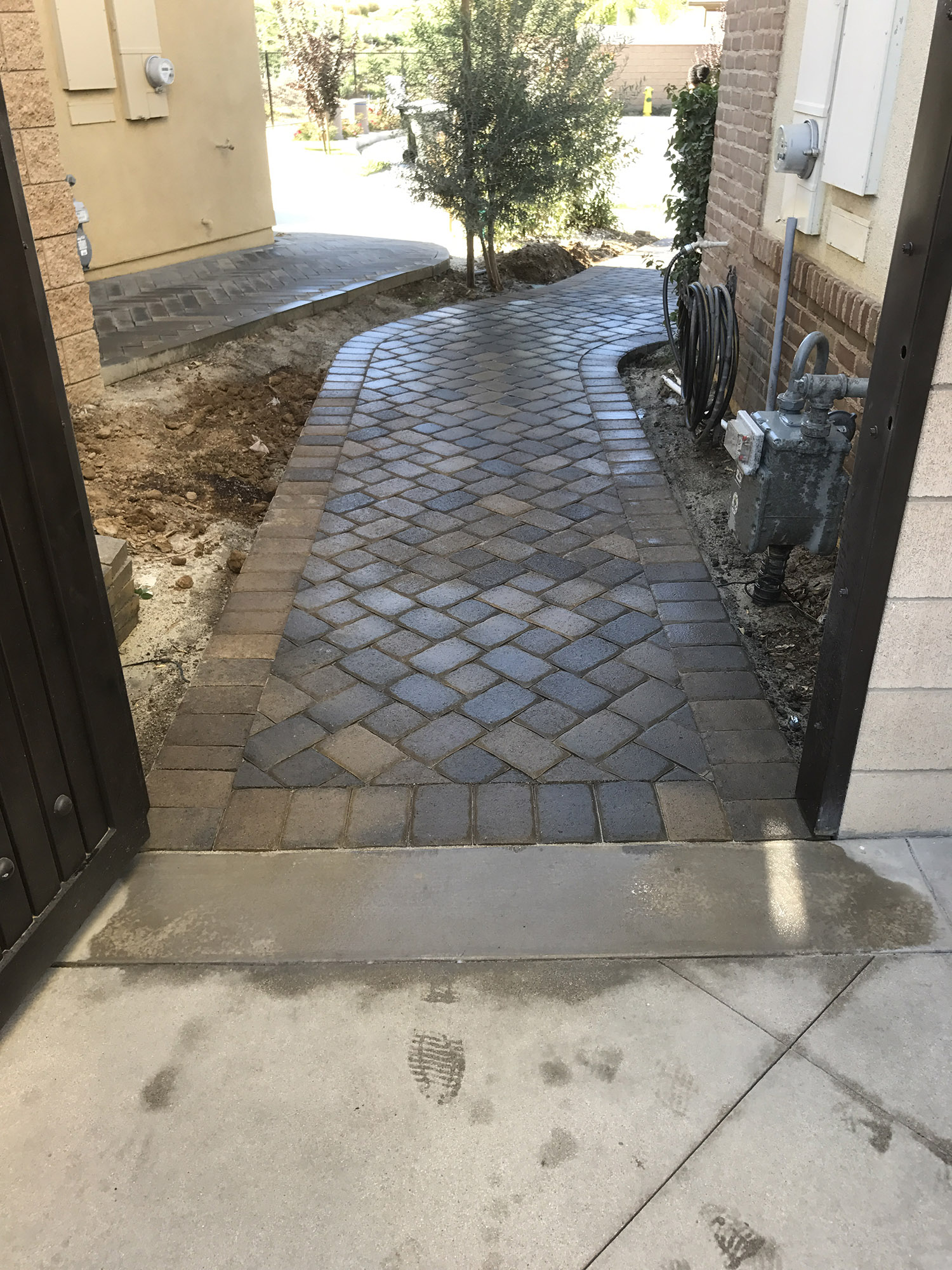 Curved garden pathway in natural stone tones connecting outdoor spaces